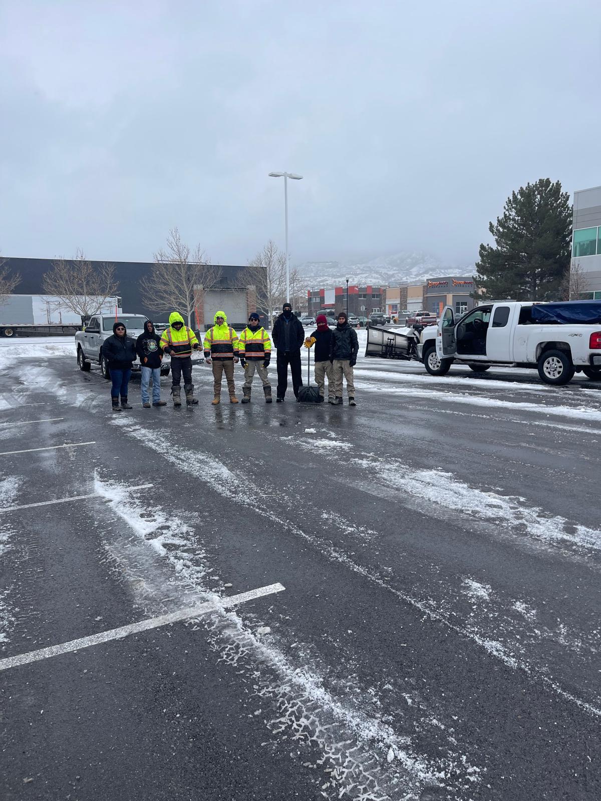 R Landscaping crew posing in high-visibility gear